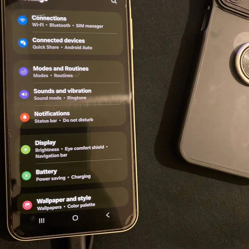 Samsung Yellow Smartphone with Black Case and White Cable